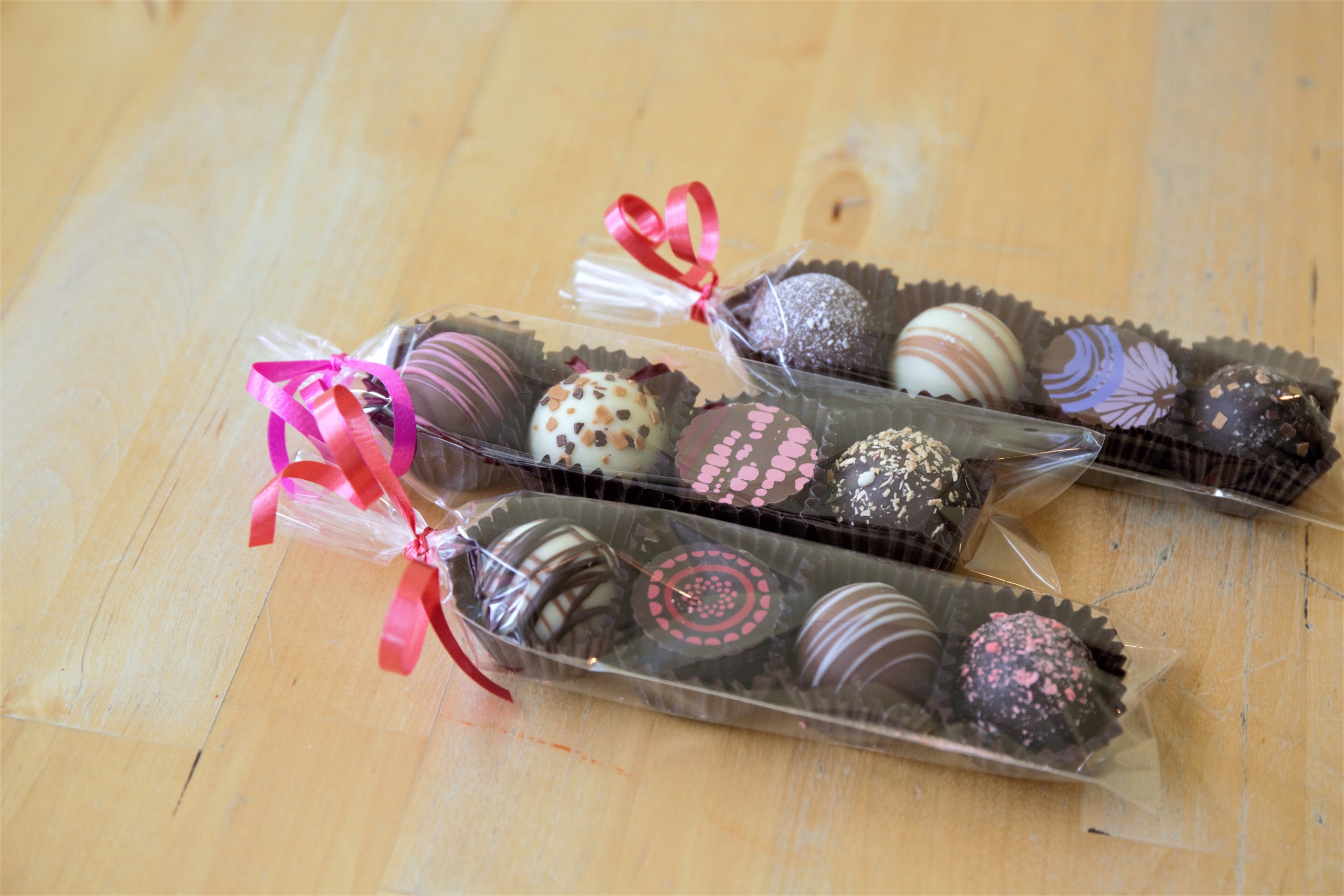 Four assorted truffles in a sleeve from the Chocolate Caper The